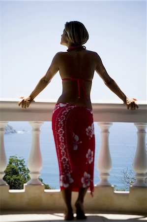 Woman on balcony overlooking ocean Stock Photo - Premium Royalty-Free, Code: 640-03265495