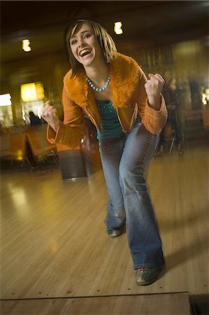 simsearch:640-03265586,k - Teenage girl making a face in a bowling alley Stock Photo - Premium Royalty-Free, Code: 640-03265575