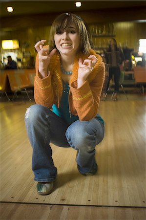 simsearch:640-03265586,k - Teenage girl making a face in a bowling alley Stock Photo - Premium Royalty-Free, Code: 640-03265576