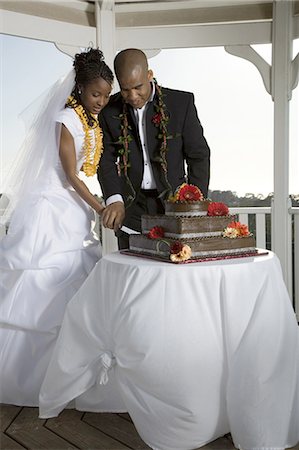 simsearch:640-03256325,k - Bride and groom cutting their wedding cake Stock Photo - Premium Royalty-Free, Code: 640-03265693