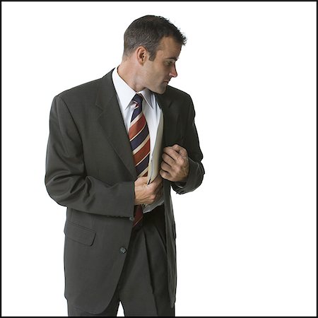 simsearch:640-03260034,k - Businessman putting files into his jacket Foto de stock - Royalty Free Premium, Número: 640-03260036