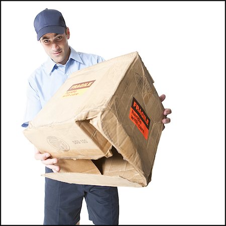 simsearch:640-03259429,k - Deliveryman holding a damaged parcel Foto de stock - Sin royalties Premium, Código: 640-03260062