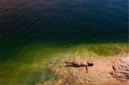 sunning - Woman lying in the water on back Stock Photo - Premium Royalty-Free, Code: 640-03260094