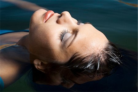 Woman floating in water Stock Photo - Premium Royalty-Free, Code: 640-03260354