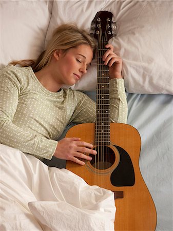 woman sleeping with her guitar Stock Photo - Premium Royalty-Free, Code: 640-03260380