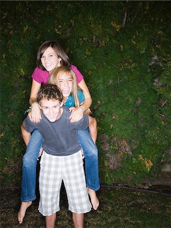 three teenagers climbing on each other Stock Photo - Premium Royalty-Free, Code: 640-03260408