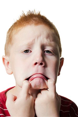 funny faces kids - Boy pulling funny face Stock Photo - Premium Royalty-Free, Code: 640-03260422