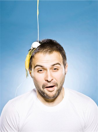 slime - man getting an egg dropped on his head Stock Photo - Premium Royalty-Free, Code: 640-03260456