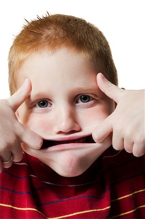 funny faces kids - Boy pulling funny face Stock Photo - Premium Royalty-Free, Code: 640-03260552