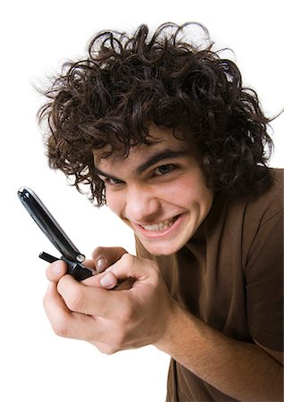 Teenage boy talking on cell phone holding backpack Stock Photo - Premium Royalty-Free, Code: 640-03260745