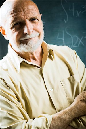 Closeup of male school teacher holding chalk Stock Photo - Premium Royalty-Free, Code: 640-03260896