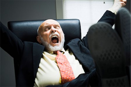 suit business man close up face one person only - Closeup of businessman yawning in office Stock Photo - Premium Royalty-Free, Code: 640-03260905