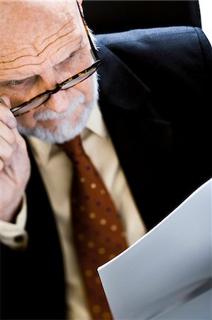 simsearch:640-03261061,k - Closeup of businessman reading report Stock Photo - Premium Royalty-Free, Code: 640-03260930