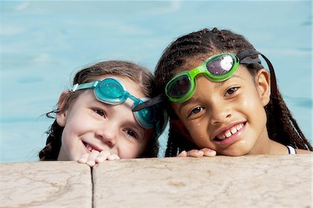 friends swimming - Girls with swimming goggles in pool Stock Photo - Premium Royalty-Free, Code: 640-03261007