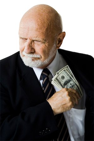 successful man with money - Closeup of businessman putting US banknotes in pocket Stock Photo - Premium Royalty-Free, Code: 640-03261058