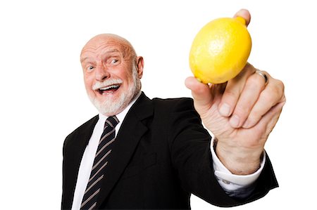 people with fruits cutout - Business man holding lemon Foto de stock - Sin royalties Premium, Código: 640-03261075