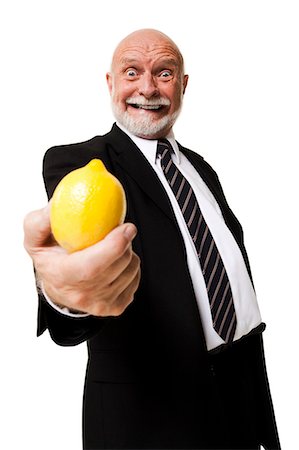 people with fruits cutout - Business man holding lemon Stock Photo - Premium Royalty-Free, Code: 640-03261076