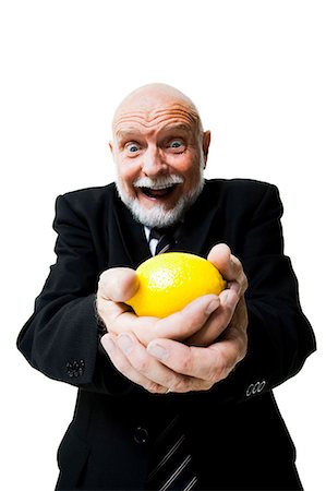 people with fruits cutout - Business man holding lemon Stock Photo - Premium Royalty-Free, Code: 640-03261078