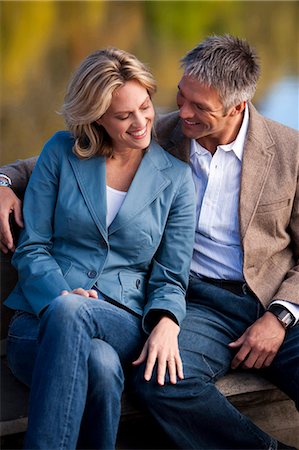 picture of two people on a park bench - Close up of man and woman smiling Stock Photo - Premium Royalty-Free, Code: 640-03261216