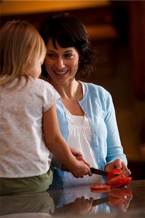 stanley knife - Mother and daughter slicing tomato Stock Photo - Premium Royalty-Free, Code: 640-03261275