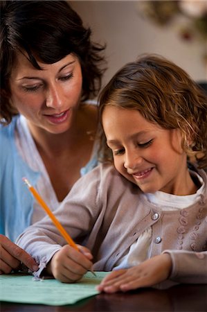Woman and daughter writing Stock Photo - Premium Royalty-Free, Code: 640-03261272