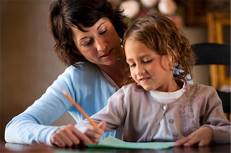 Mother helping daughter write Stock Photo - Premium Royalty-Free, Code: 640-03261273