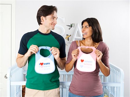 pregnant couple crib - Married couple with baby bibs Stock Photo - Premium Royalty-Free, Code: 640-03261338