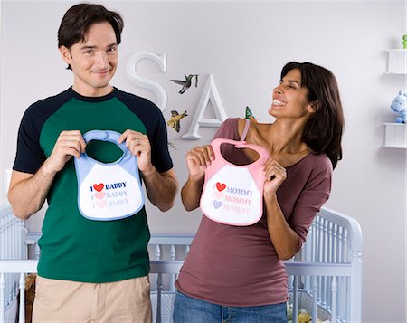 parent crib baby - Married couple with baby bibs Stock Photo - Premium Royalty-Free, Code: 640-03261339
