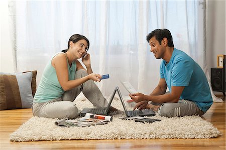 Man and woman on carpet with laptops Stock Photo - Premium Royalty-Free, Code: 640-03261444