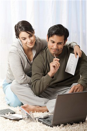 Man and woman on carpet with laptop Stock Photo - Premium Royalty-Free, Code: 640-03261442