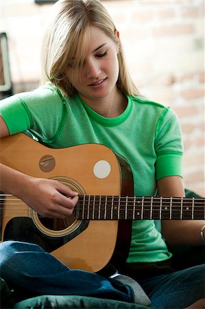 playing guitar close up - Woman holding guitar Stock Photo - Premium Royalty-Free, Code: 640-03261466