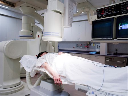 Woman undergoing x-ray in lab Stock Photo - Premium Royalty-Free, Code: 640-03261696