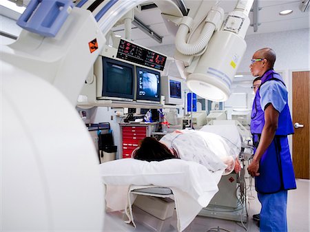 Woman undergoing x-ray in lab Stock Photo - Premium Royalty-Free, Code: 640-03261697