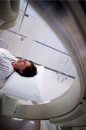 person in hospital bed overhead - Aerial of woman on diagnostic bed Stock Photo - Premium Royalty-Free, Code: 640-03261706