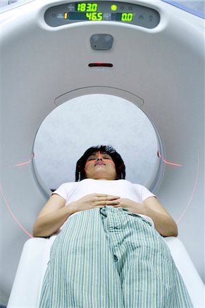 Woman entering MRI machine Stock Photo - Premium Royalty-Free, Code: 640-03261708