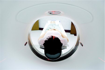 Patient entering MRI machine from behind Stock Photo - Premium Royalty-Free, Code: 640-03261714