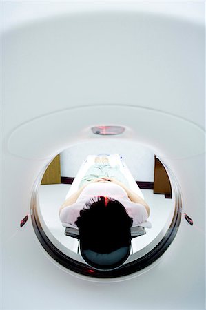 Patient entering MRI machine from behind Stock Photo - Premium Royalty-Free, Code: 640-03261715