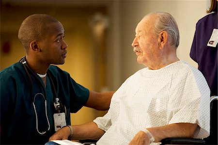 Mature man in wheelchair with doctor and nurse Stock Photo - Premium Royalty-Free, Code: 640-03261745