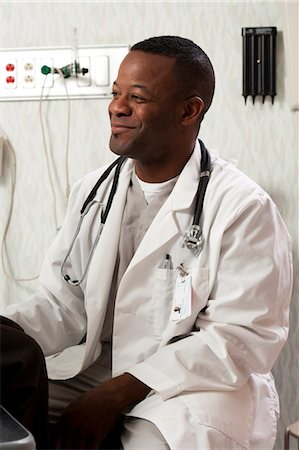 simsearch:640-03261804,k - Woman talking to doctor in examining room Stock Photo - Premium Royalty-Free, Code: 640-03261797