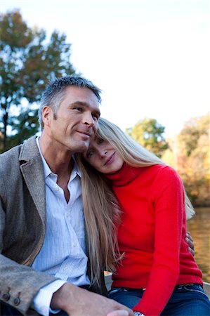 Couple sitting by water Stock Photo - Premium Royalty-Free, Code: 640-03261943