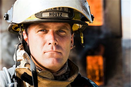 firefighter close - Portrait of a firefighter with fire in background Stock Photo - Premium Royalty-Free, Code: 640-03262195