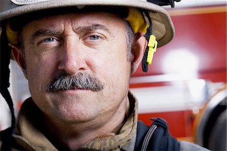 Portrait of a firefighter smiling Stock Photo - Premium Royalty-Free, Code: 640-03262219