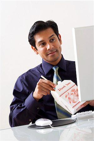 simsearch:640-01351279,k - Male sitting at desk with computer and Chinese take out Stock Photo - Premium Royalty-Free, Code: 640-03262293