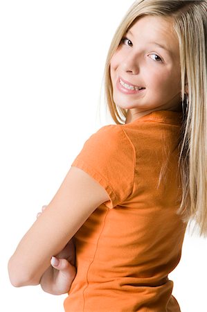 Portrait of a girl smiling with arms crossed Stock Photo - Premium Royalty-Free, Code: 640-03262302