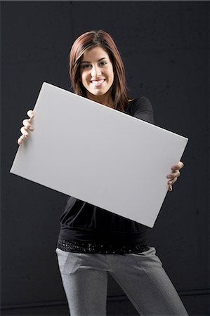 person holding blank sign - Woman standing with blank sign Stock Photo - Premium Royalty-Free, Code: 640-03262354