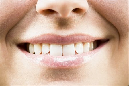 Closeup of woman biting lip smiling Stock Photo - Premium Royalty-Free, Code: 640-03262370