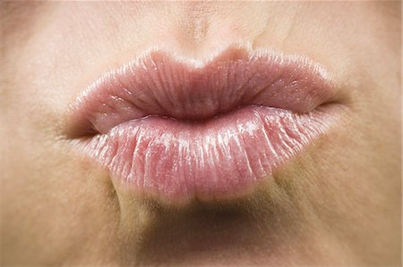 Closeup of woman biting lip smiling Stock Photo - Premium Royalty-Free, Code: 640-03262371