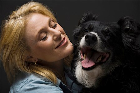 people animal cuddle - Portrait of a woman with black dog Stock Photo - Premium Royalty-Free, Code: 640-03262468