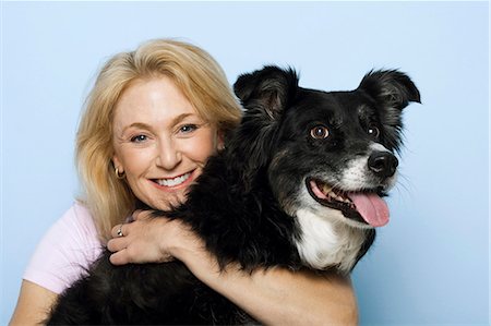 people animal cuddle - Woman hugging black dog Stock Photo - Premium Royalty-Free, Code: 640-03262474