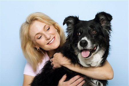 people animal cuddle - Woman hugging black dog Stock Photo - Premium Royalty-Free, Code: 640-03262472